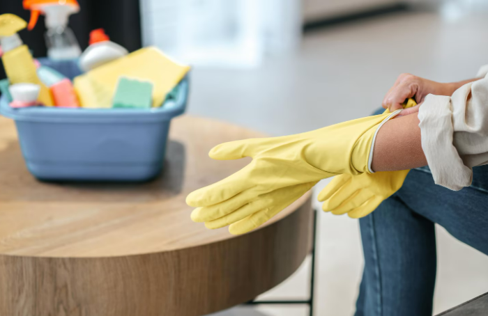 Persona usando guantes para limpiar